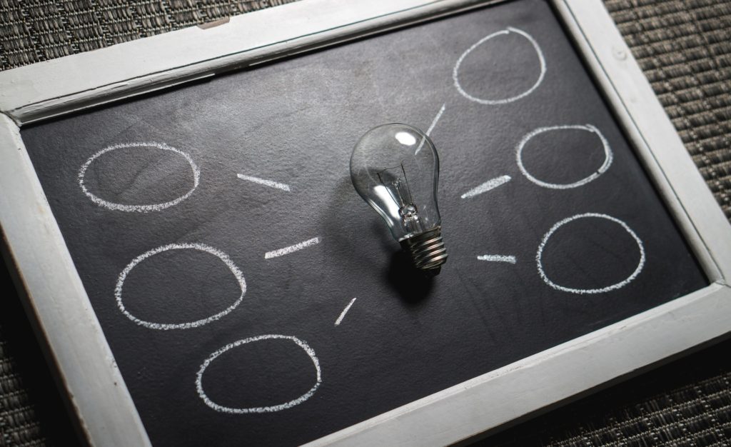 chalkboard drawing with light bulb sitting on top