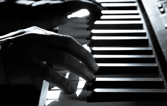 hands on a piano keyboard