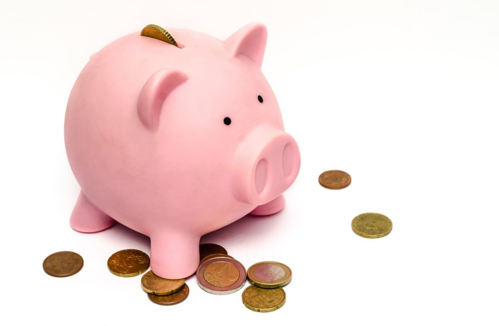 piggy bank with coins on table