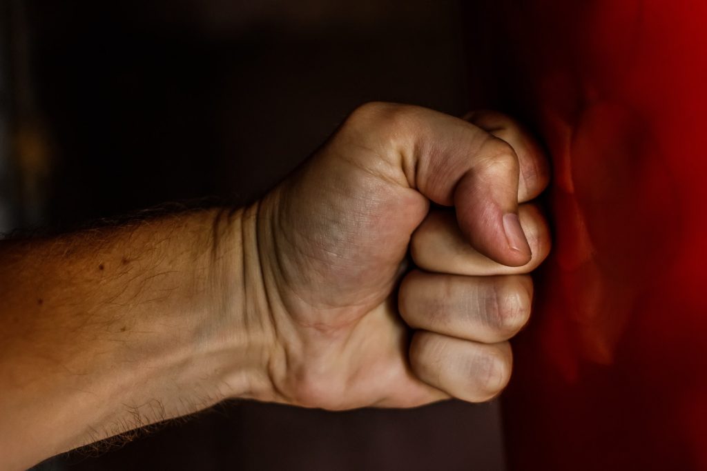 clenched fist against padded mat