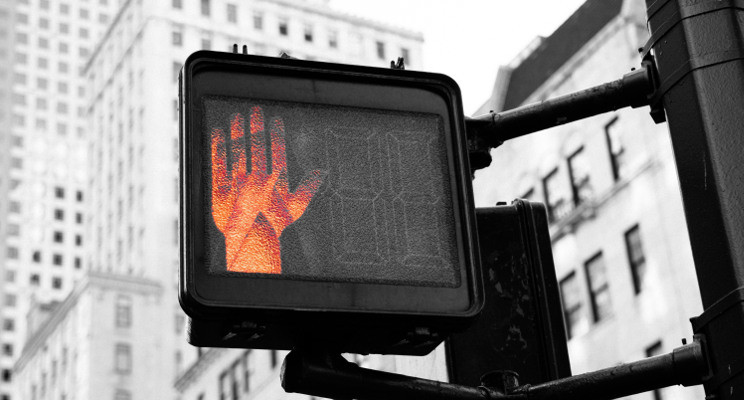 red hand indicating stop at crosswalk