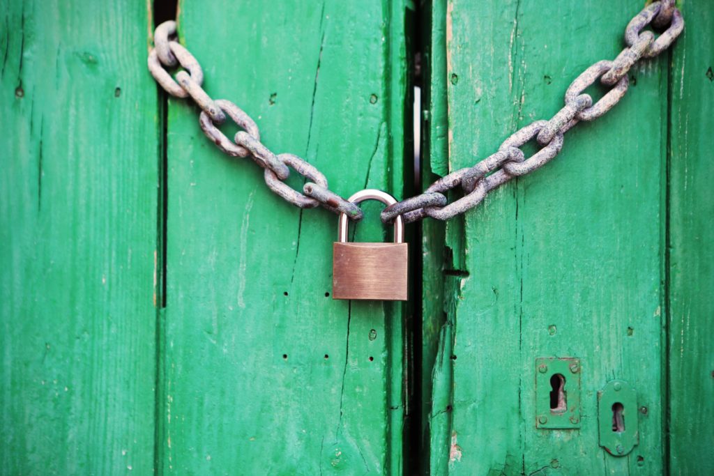 green door with closed lock and chain