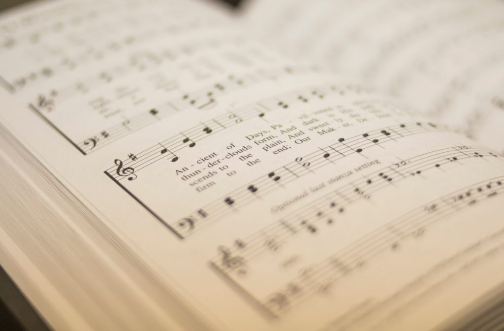 open hymnal focused on old hymn text