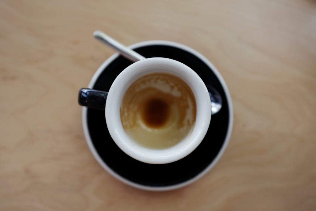 coffee mug and spoon on saucer